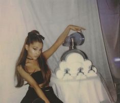 a woman sitting on the floor next to a table with a cake and soap dispenser