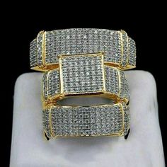 two yellow gold rings with white diamonds on them