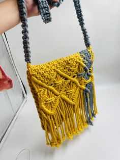 Add a different accessory to your wardrobe, make a statement with this eco-friendly Macrame Sling bag while feeling confident you are helping your earth.  Natural, simple and in Mustard & grey and creamy white this unlined bag is handcrafted by artisans in India from up-cycled cotton denim and recycled material in intricate knotted patterns in the macrame style. Tie the shoulder strap to your desired length. Customisable in any color. Size- Width- 9.5 Inches, Length- 9.5 Inches. Please let me know if you have any questions regarding any of my product. Macrame Sling Bag, Macrame Shoulder Bag, Macrame Style, Bag Macrame, Macrame Purse, Feeling Confident, Bag Handmade, Boho Stil, Purse Bag