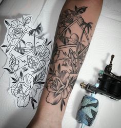 a black and white tattoo on the arm of a person's hand next to an ink roller