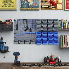 there are many tools hanging on the wall next to shelves with books and other items