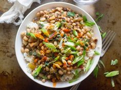 a white bowl filled with rice, beans and veggies on top of a table