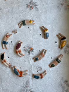 several small figurines are arranged in the shape of a circle with numbers on them