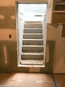 an empty room with stairs leading up to the door and window in the wall that has been painted