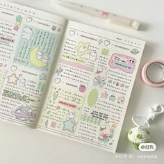 an open notebook with stickers on it next to a pair of scissors and other items