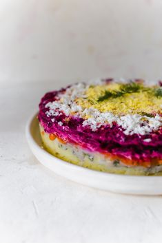 a colorful cake on a white plate with sprinkles