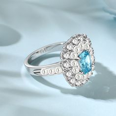 This beautiful sterling silver double halo pearl aquamarine ring showcases a unique design and elegance. It features a pearl delicately surrounding the central Sohae sapphire, creating a mysterious yet elegant atmosphere. The design of the ring is full of artistry and subtlety, with each pearl and sapphire radiating its own light, blending perfectly with the silver material to present a unique aesthetic. Whether worn for everyday wear or as a sophisticated adornment for important occasions, this Elegant Blue Pearl Ring With Gemstone, Elegant Blue Topaz Halo Ring For Wedding, Elegant Blue Halo Ring, Blue Pearl Ring For Anniversary, Elegant Blue Pearl Ring, Elegant Blue Pearl Ring As Gift, Elegant Blue Pearl Ring For Formal Occasions, Elegant Light Blue Pearl Jewelry, Elegant Silver Pearl Ring With Halo