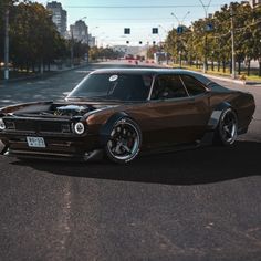 a brown muscle car parked on the street