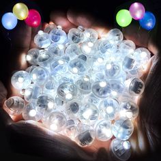 a bunch of lights that are in the palm of someone's hand with their hands