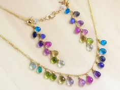 A bevy of luscious semi precious gemstones are combined in this colorful, rainbow drop Necklace. Here I have wire-wrapped the best quality gemstone drops in a rainbow palette of sea foam blue, green, violet and pink, purple and blues. Each drop sparkles like crazy and is very very clear! The design is very modern and [...] Sapphire Jewelry Set, Multi Gemstone Necklace, Blue Gemstone Earrings, Rainbow Gemstones, Earrings Colorful, Earrings Wire, Rainbow Jewelry, Multi Sapphire, Rainbow Necklace