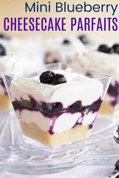 mini blueberry cheesecake parfaits on a clear glass plate with the title