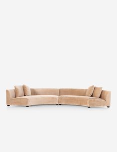 the curved sectional sofa is shown in beige