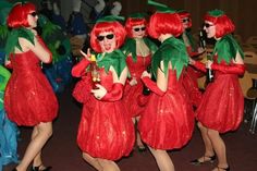 some very pretty ladies in red dresses and green hats