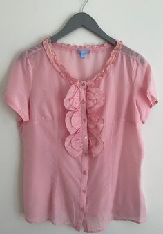 "A cute and classy silk cotton blend pink shirt that is perfect for spring and summer! Usher in warmer weather with this top, wear it plain or under a blazer or sweater, you can't go wrong! A lovely ruffled front and collar adds just the right amount of wonder to this blouse. Slightly sheer, you can wear it over a cami or not.  70% cotton and 30% silk, this blouse looks light and airy with just a bit of shine thanks to the silk.  Pair it with jeans, pants, skirts, shorts...the possibilities are endless! Look effortless in this beauty whether at work or going out.  A great Mother's Day gift. I have washed this shirt in cold water on a delicate cycle and hung to dry with no compromise to quality. Size L but please check dimensions below. The fit is loose. Chest ( length from armpit to armpit Summer Cotton Tops, Pants Skirts, Work Shirt, Top Vintage, Spring Shirts, Pink Shirt, Pink Silk, Work Shirts, Vintage Silk