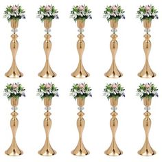 a set of twelve golden vases with flowers on each one, all in different sizes