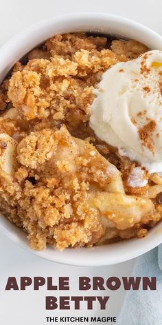 a bowl filled with apple brown betty next to a cup of ice cream on top of a table