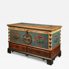 an old wooden chest with painted designs on it