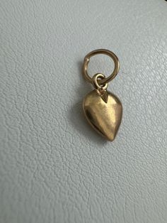 14k Vintage Heart Charm This 14k Vintage Heart Charm is a delicate and beautiful addition to any jewelry collection. The charm measures 13.6mm x 6.1mm and weighs 0.36 grams. This piece, like all our jewelry, is a unique find--once it's gone, it's gone--unlikely to be sourced again! Choosing this piece is a win-win: You'll stand out from the crowd & help the environment by shopping sustainably! Why You'll Love It:      Sweet Design: The heart shape adds a loving and sweet touch to your look. Help The Environment, Vintage Heart, Gold Design, Memorable Gifts, Heart Shape, Charm Jewelry, Heart Charm, Charm Necklace, Unique Pieces