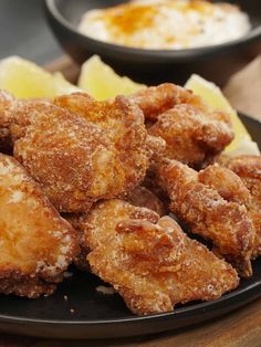 some fried food is on a black plate