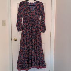 Gorgeous, Comfy Maxi Dress With Long Sleeves, Smocked Waistline, And Ruffled Hem. V Neck With A Hook And Eye Closure So You Can Wear It Open Or Closed. Red Floral Pattern On Navy Blue Background With Touches Of Gold. Tags Still Attached! Please Note, This Is A Petite Medium. I Am About 5' 5" And It Hits Right Above My Ankles. Pit To Pit 16" Shoulder To Hem 49" Sleeves From Shoulder 20.5" Casual Fitted Boho Dress With Long Sleeves, Casual Fitted Long Sleeve Boho Dress, Fitted Casual Boho Cotton Dress, Casual Blue Boho Dress For Fall, Fitted Long Sleeve Cotton Boho Dress, Blue Boho Print Long Sleeve Midi Dress, Blue Long Sleeve Midi Dress With Boho Print, Comfy Maxi Dress, Maxi Dress With Long Sleeves