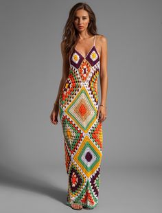 a woman in a multicolored crochet dress with the words, free pattern