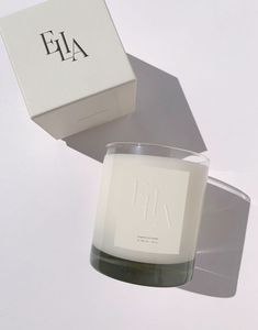 a candle sitting on top of a table next to a box with the word fa