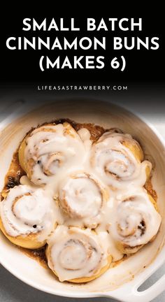 cinnamon buns with icing in a white dish on a table next to the words, small batch cinnamon buns makes 6