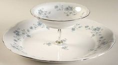 a white plate with blue flowers on it and an upside down bowl in the middle