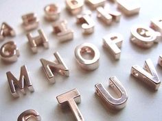 some type of metal letters and numbers on a white surface with the words'corine spalding update those colorful alphabet magnets with spray paint diy