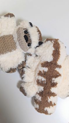 two stuffed animals laying next to each other