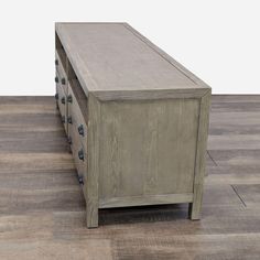 a large wooden chest with metal knobs on the top and bottom, sitting on a hard wood floor