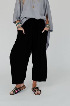 Elevate your boho wardrobe with the Blissful Drifter Pants, so cozy and cool with their trendy wide legs and comfortable fit, you'll feel stylish and confident in any setting! Whether you pair them with your favorite tee or a cozy sweater, these pants are a versatile addition because they feature: Comfortable, breezy, solid linen fabric Loose and slouchy bottoms silhouette High - rise elastic drawstring waistband Statement patch pocket details along the side with pleated details along the bottom Bohemian Lounge Pants With Pockets, Bohemian Loungewear Pants With Pockets, Relaxed Ankle-length Harem Pants For Loungewear, Comfortable Straight Leg Harem Pants For Loungewear, Trendy Wide Leg Harem Pants For Fall, Casual Rayon Bottoms For Fall, Bohemian Lounge Pants With Elastic Waistband, Comfortable Black Wide-leg Harem Pants, Bohemian Harem Pants With Elastic Waistband For Loungewear