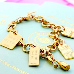 GOLD CHARM BRACELET WITH 12 LUGGAGE TAG CHARMS (MINI PLANE SHIPS JUNE) - JET SET CANDY  (4401092821080) Best Champagne, Passport Stamps, Travel Charms, Gold Charm Bracelet, Charms And Charm Bracelets, Car Charms, Birthstone Charms, Champagne Gold, Charm Gift