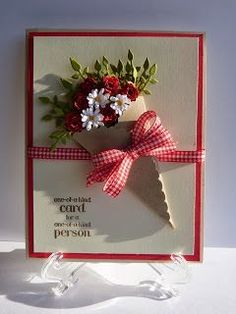 a red and white card with flowers on it