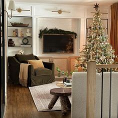 a living room filled with furniture and a christmas tree in front of a flat screen tv