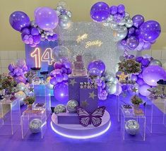 a table with balloons, cake and decorations for a birthday party or special occasion at the same time