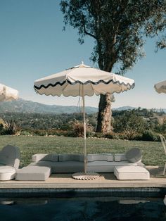 an outdoor lounge set next to a swimming pool