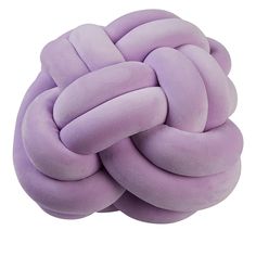 a purple knot pillow sitting on top of a white surface