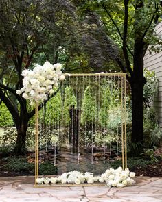 an outdoor ceremony with white flowers and greenery