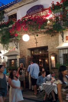 many people are walking in front of a restaurant