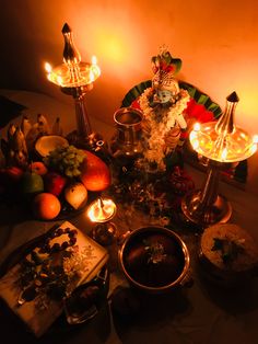 a table topped with lots of food and candles