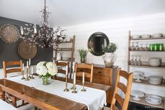 the dining room table is set with white flowers