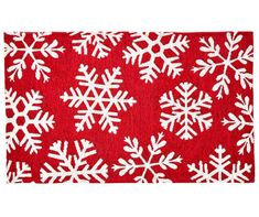 a red and white rug with snowflakes on the front, in various sizes