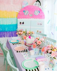 the table is set for a birthday party with colorful decorations and decorating on it