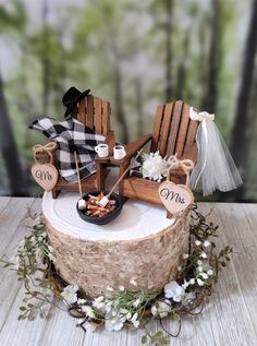 a wedding cake with two adiron chairs