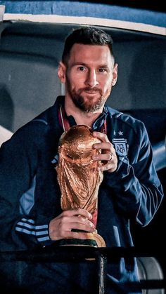 a man holding a soccer ball in his hands