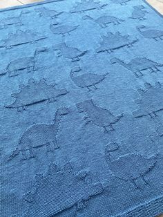 a blue rug on the floor with an elephant design