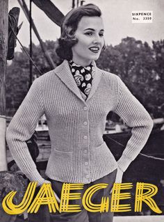 a woman wearing a sweater and tie standing in front of a boat