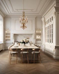 an elegant kitchen with white cabinets and marble counter tops, chandelier above the island