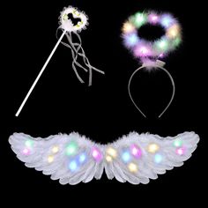 an assortment of angel wings and headbands with flashing lights on black background,